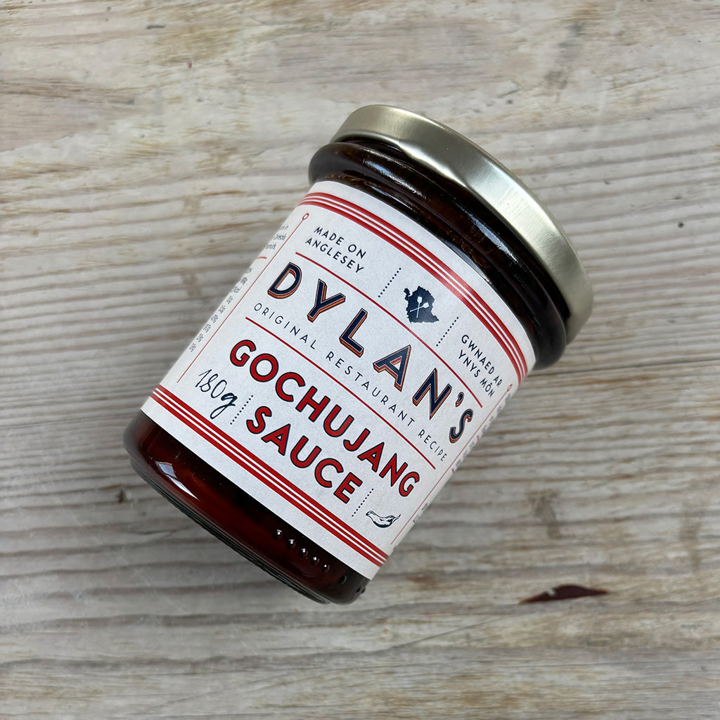 Jar of Dylan's Gochujang Sauce on a wooden surface