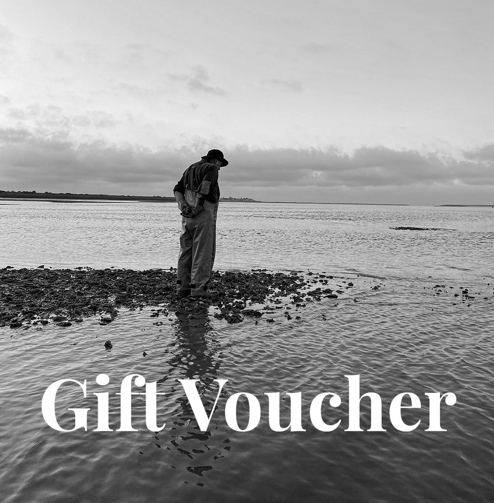 Person standing on a beach with 'Gift Voucher' text overlay