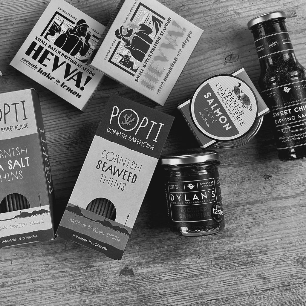 Assorted food products including boxes, jars, and bottles on a wooden surface.