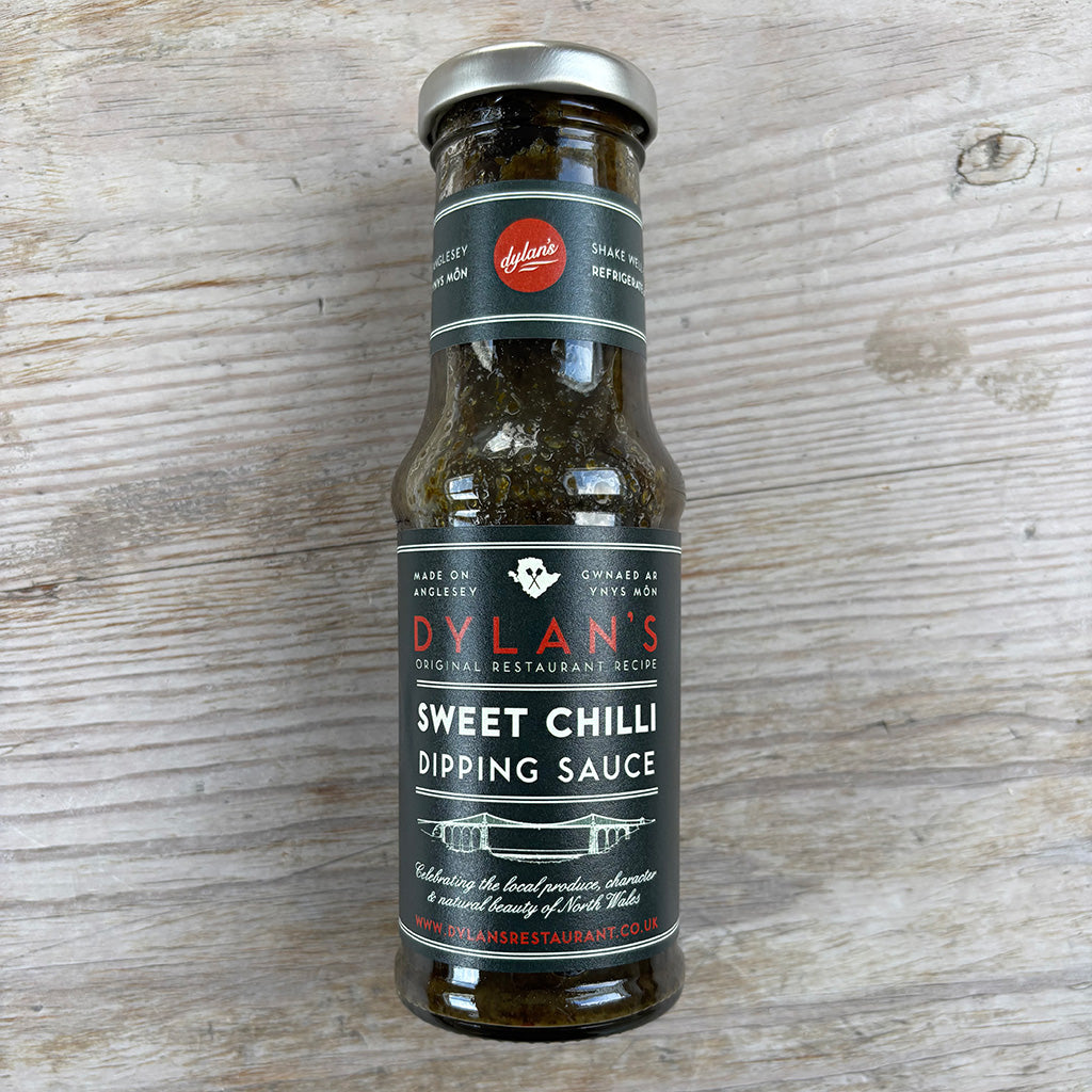 Bottle of Dylan's Sweet Chilli Dipping Sauce on a wooden surface